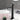 charmydecor matte black tall faucet with water flow beside vessel sink