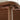 Close-up of a brown metal chair arm with screws and a blurred background