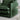 Green sofa in a living room setting with a white side table and rug.