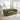 Green sofa in a living room with a fireplace and decor items.