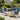 Charmydecor Nusa 4-piece black outdoor conversation set with acacia wood table styled beside a swimming pool