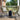 Charmydecor Nusa green PE rattan patio chairs set of 2 with black iron frames on a covered deck