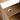 CharmyDecor oak-look bathroom vanity interior shelf close-up showing the circular covered plumbing opening