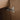 CharmyDecor oak-look double sink bathroom vanity close-up of a cabinet door hinge against the wood-grain finish