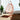 Charmydecor orange-red hanging egg chair with white cushion in bright indoor coastal room