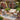 Charmydecor outdoor 4-piece acacia wood sofa set with rope panels and beige cushions styled on a brick patio