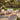 Charmydecor outdoor 4-seater acacia wood patio conversation set with cream cushions and coffee table in a garden setting
