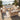 Charmydecor outdoor 7-seater acacia wood patio chat set with beige cushions on coastal terrace