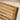 Close-up of a wooden bench with slatted backrest on a blurred background