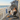 charmydecor outdoor hanging egg chair with stand and dark gray cushion on a coastal balcony overlooking the beach