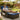 Man relaxing on a patio chair with blue cushions in a garden setting