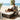 Charmydecor outdoor rattan sofa bed with side table and beige cushions on coastal patio