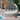 Round outdoor daybed with canopy on a wooden deck by a pool