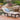 Puerta outdoor wicker chaise lounge with beige cushion beside a pool from charmydecor