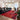 CharmyDecor red patchwork area rug paired with black leather sofa and cream lounge chair in modern living room