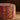 CharmyDecor round ottoman close up showing textured jacquard upholstery and piped edging