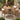 charmydecor round outdoor dining table with four acacia wood rope chairs and beige cushions on brick patio