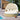 Round outdoor daybed with canopy on a wooden deck by a pool