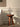 charmydecor sculptural cast iron candle holder on wooden stool with lit candles