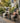 Charmydecor set of 2 black folding Adirondack chairs styled with blankets on an outdoor garden deck