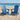 charmydecor set of 2 navy blue solid wood Adirondack chairs styled on beach