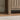Close-up of a wooden cabinet corner with a neutral background