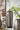 Decorative vase with green branches on a blurred background