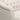 Close-up of a tufted beige fabric headboard
