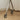 Close-up of a metal leg with wheels on a wooden floor.