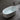 CharmyDecor stone resin bathtub filled with water, viewed from above with the center drain and overflow visible.