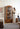 charmydecor tall teak arched glass cabinet styled in modern living room
