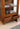 charmydecor close up of teak wood arched cabinet glass shelves detail