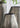 Decorative vase with textured surface and black rim against a neutral background