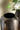 Decorative vase with wavy pattern in front of a blurred floral arrangement