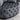 Gray tufted ottoman on a light gray carpet