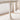 Close-up of a white table leg in a minimalistic room with a rug and decorative object.