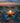 charmydecor turquoise blue wooden Adirondack chairs styled around an outdoor beach fire pit at sunset
