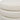 Side seam close up of ivory boucle upholstered stool ottoman round cushion layers