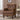 Brown leather armchair in a room with a side table and window.