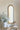 charmydecor vintage gold arched mirror above console table with floral decor