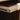 Close-up of a wooden cutting board with a dark background