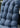 Blue cushion with water droplets on a blurred outdoor background