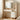 Charmydecor white makeup vanity with tri-fold mirror, Hollywood lights, USB ports, open shelves, and five drawers in a bright bedroom