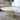 Charmydecor white marble coffee table with round natural stone top in a bright modern living room