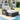 Outdoor patio furniture set with cushions by a poolside.