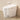 CharmyDecor white smart toilet with bidet viewed at an angle with a wall-mounted remote and lower foot sensor.