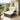 Outdoor patio chair with beige cushions on a balcony with a scenic view.