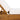 Close-up of Charmydecor teak finish acacia wood chaise lounge frame with thick cream cushion