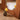 Close-up of pine wood mirror base with yellow rose in glass vase on herringbone floor