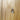 Close-up of silver handle on carved sunburst cabinet door